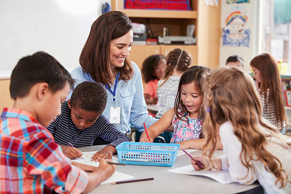 Teacher in Class with Crisis Alert Badge